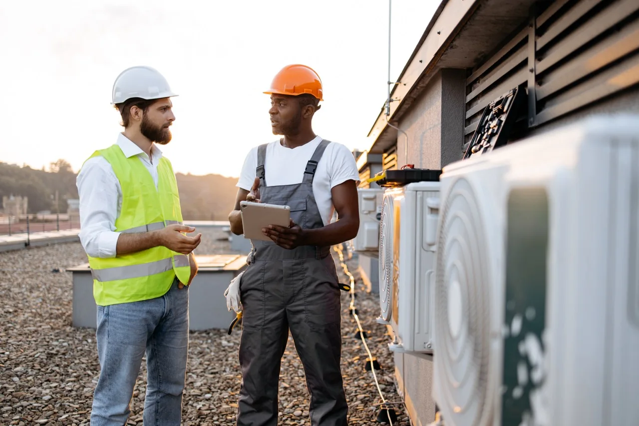 HVAC professionals reviewing outdoor equipment options