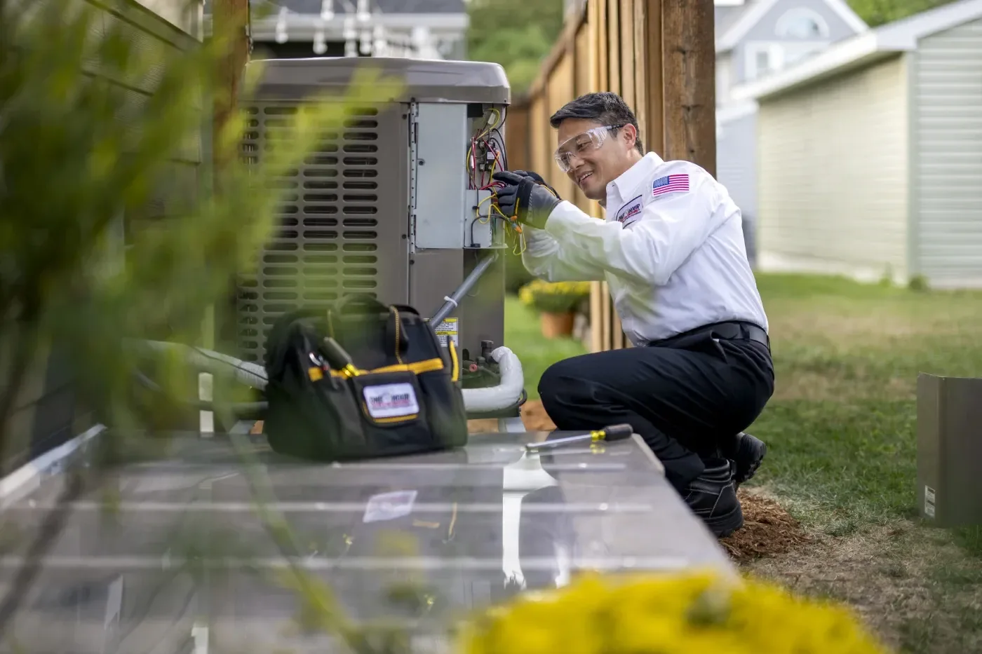 Technician inspecting a residential air conditioning unit